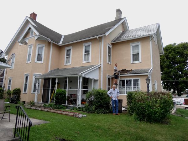 Exterior painting on a two-story house