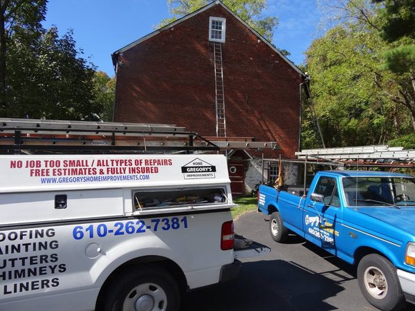 The two work trucks loaded with ladders