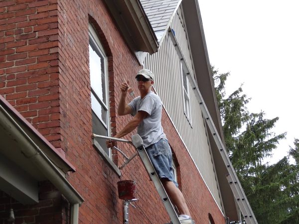 Painting window trim on a brick house
