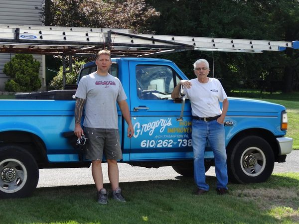 Two of the crew with the blue work truck
